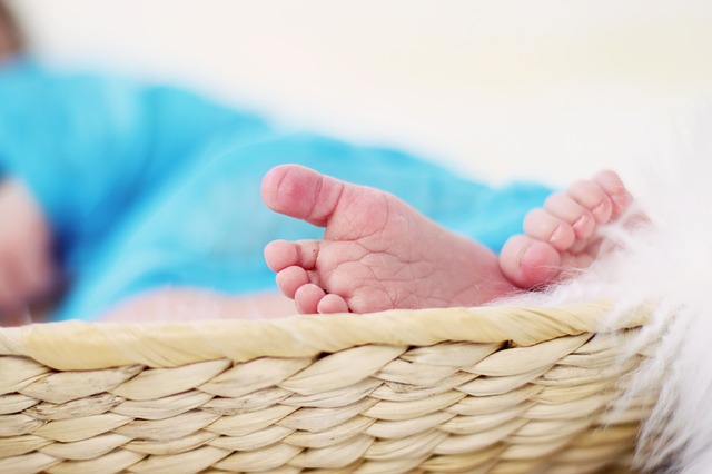 The tiny feet of a newborn