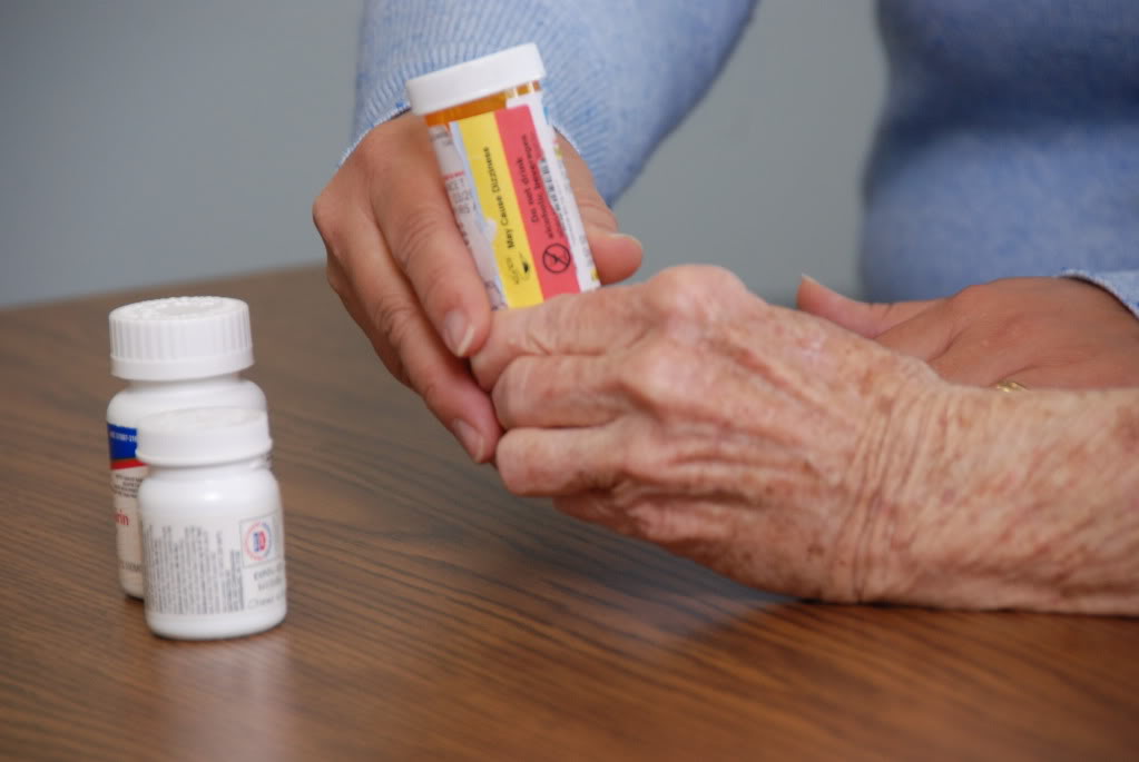 Hands holding a prescription bottle